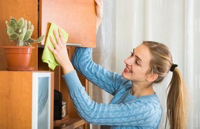 Girl Dusting Cabinets